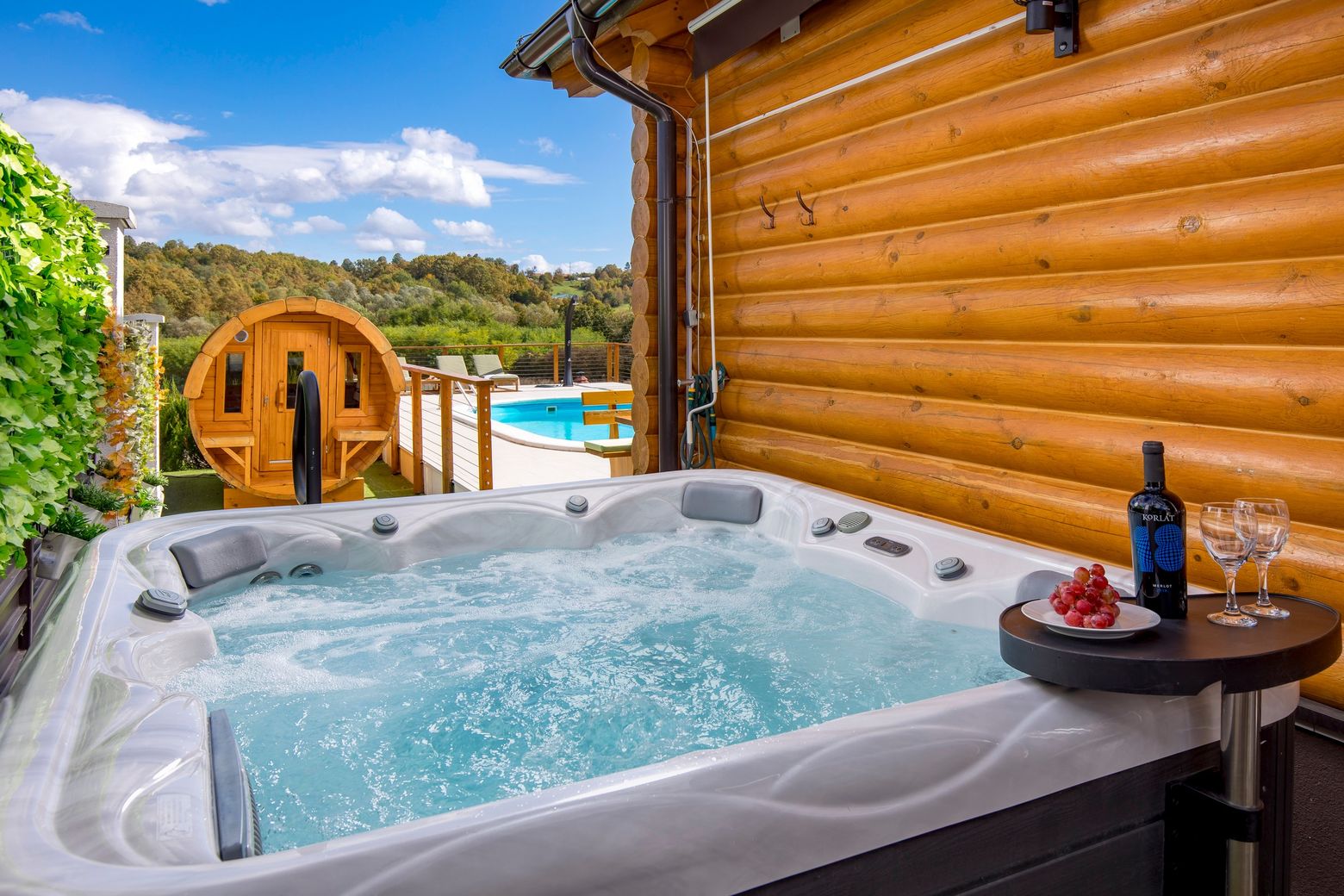 Jacuzzi uz kuću, u pozadini bačva-sauna i bazen
